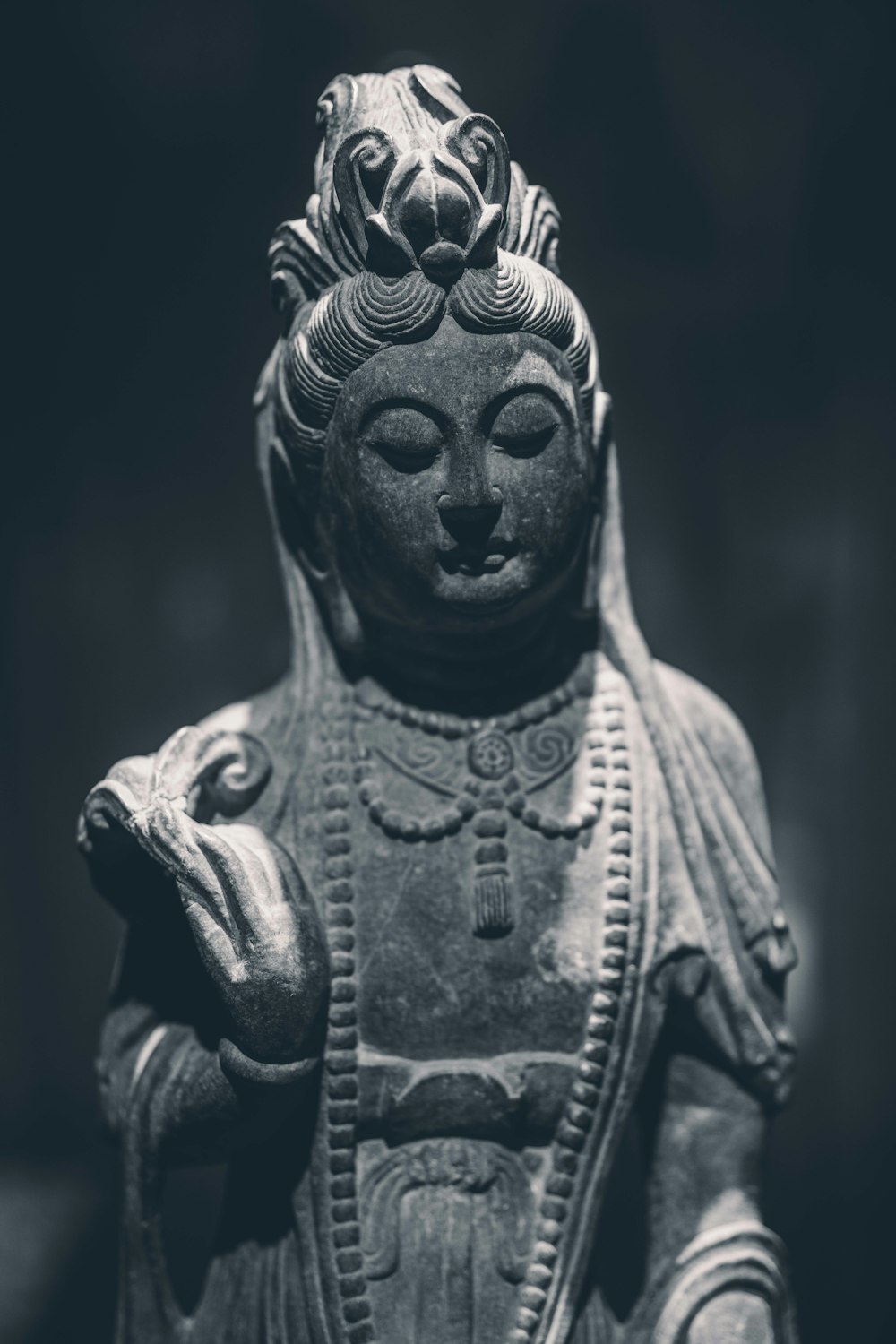 a black and white photo of a buddha statue