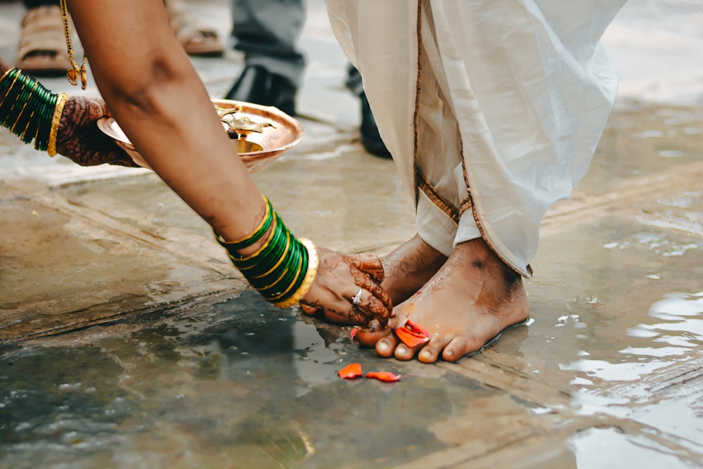 a couple of people standing on top of a wet ground