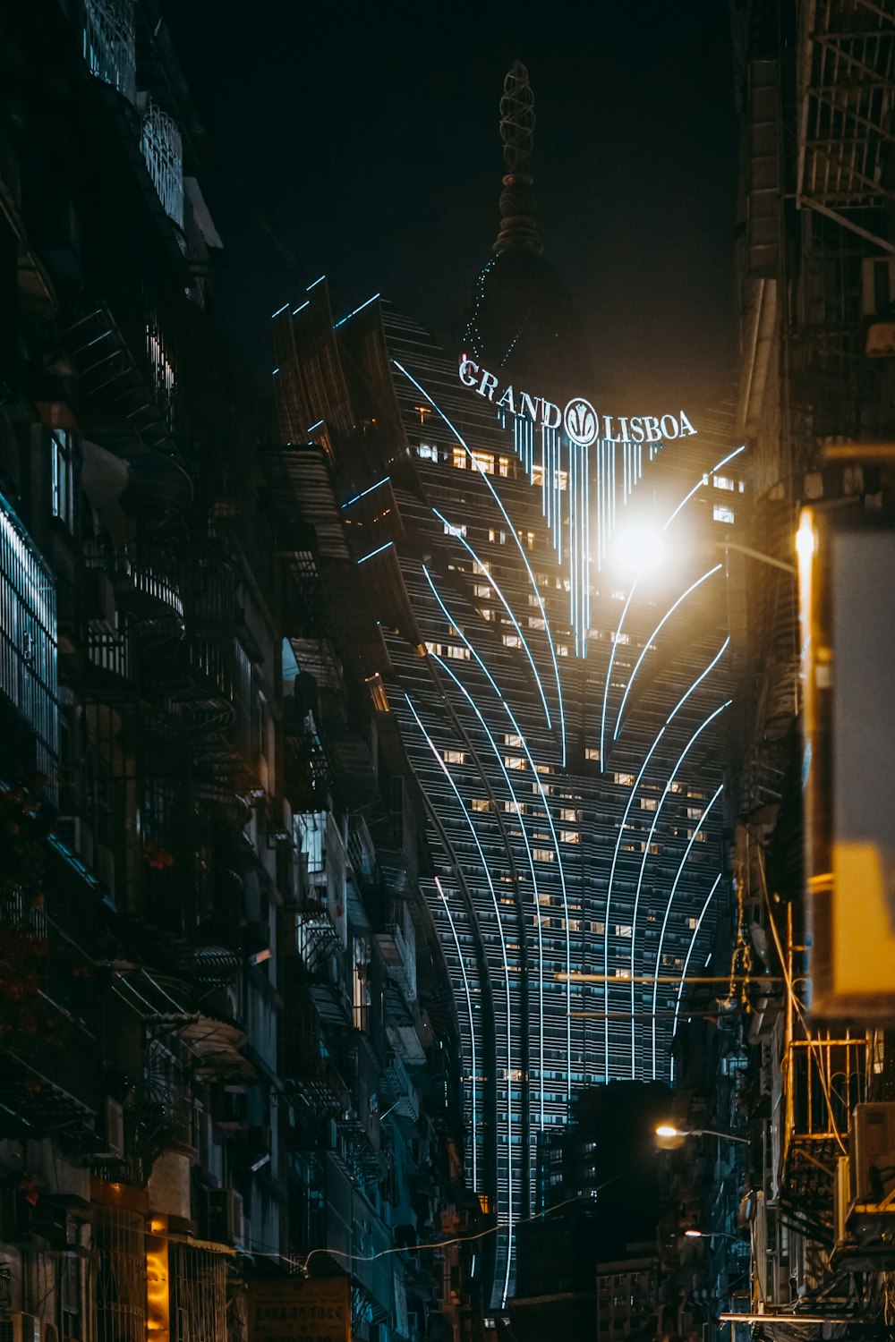 a city street at night with a lit up sign