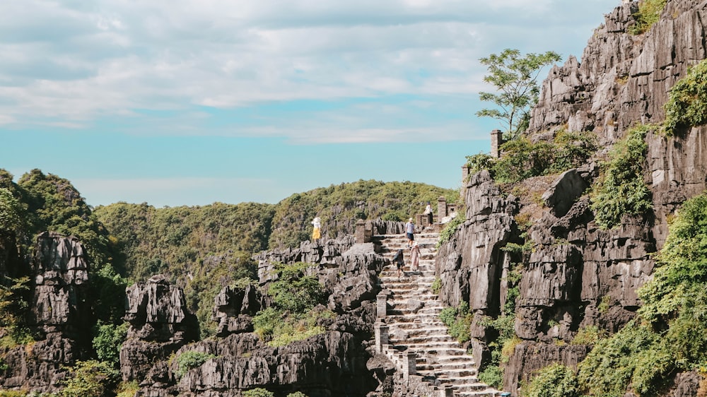 a group of people standing on top of a cliff