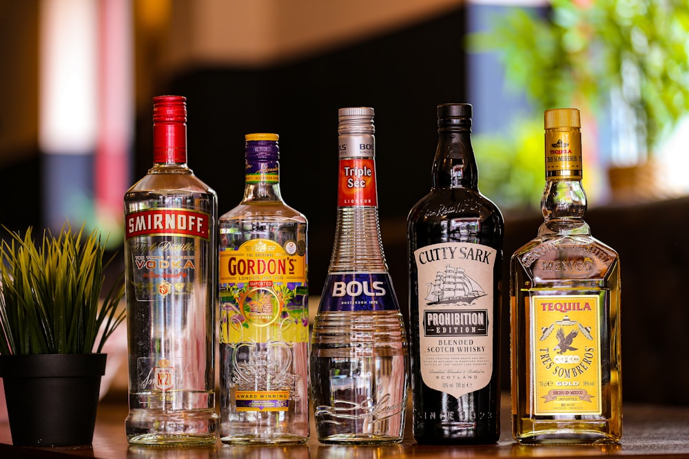 a group of liquor bottles sitting on top of a table