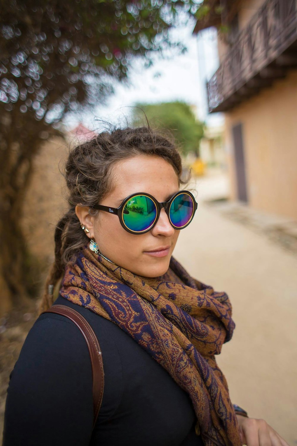 a woman wearing sunglasses and a scarf