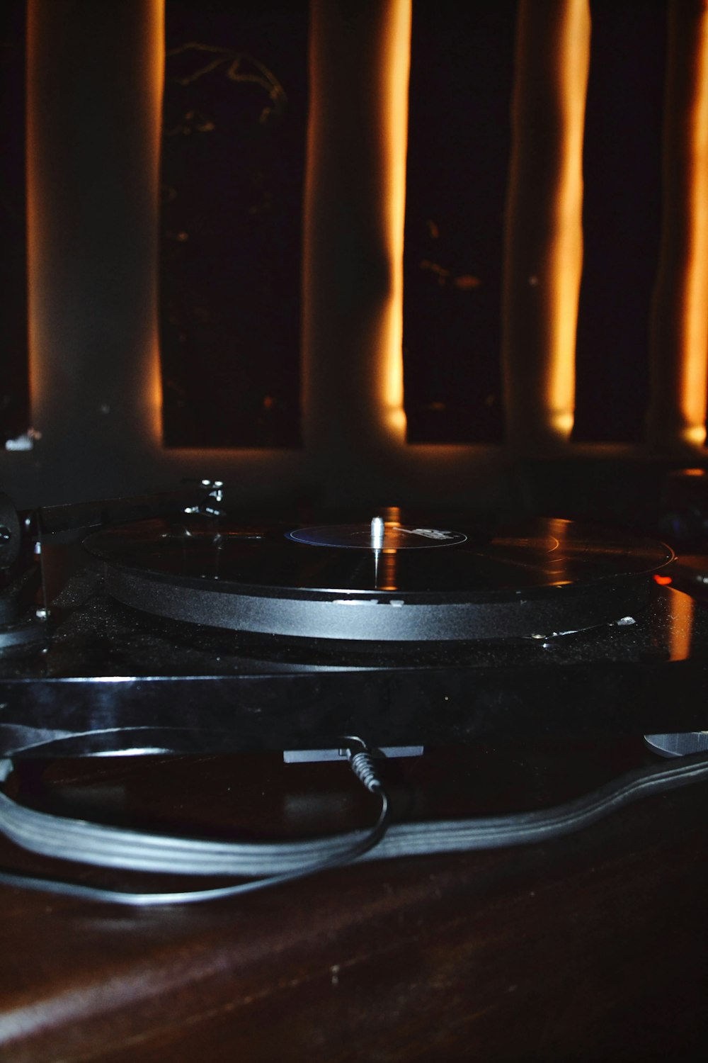 a record player sitting on top of a wooden table