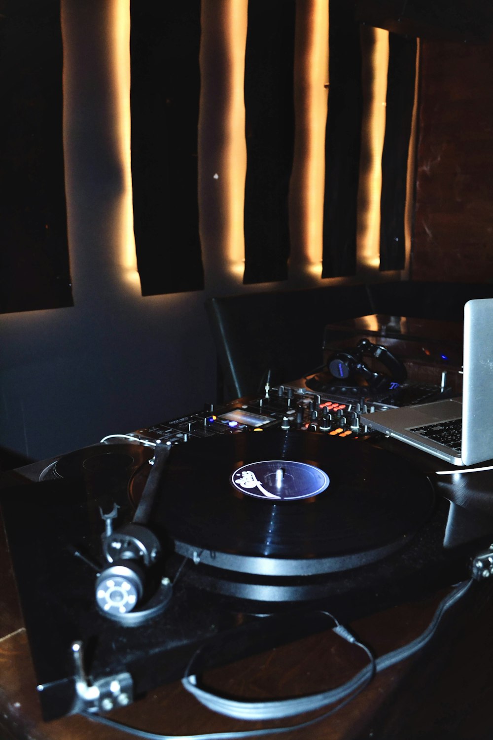 a record player and a laptop on a table