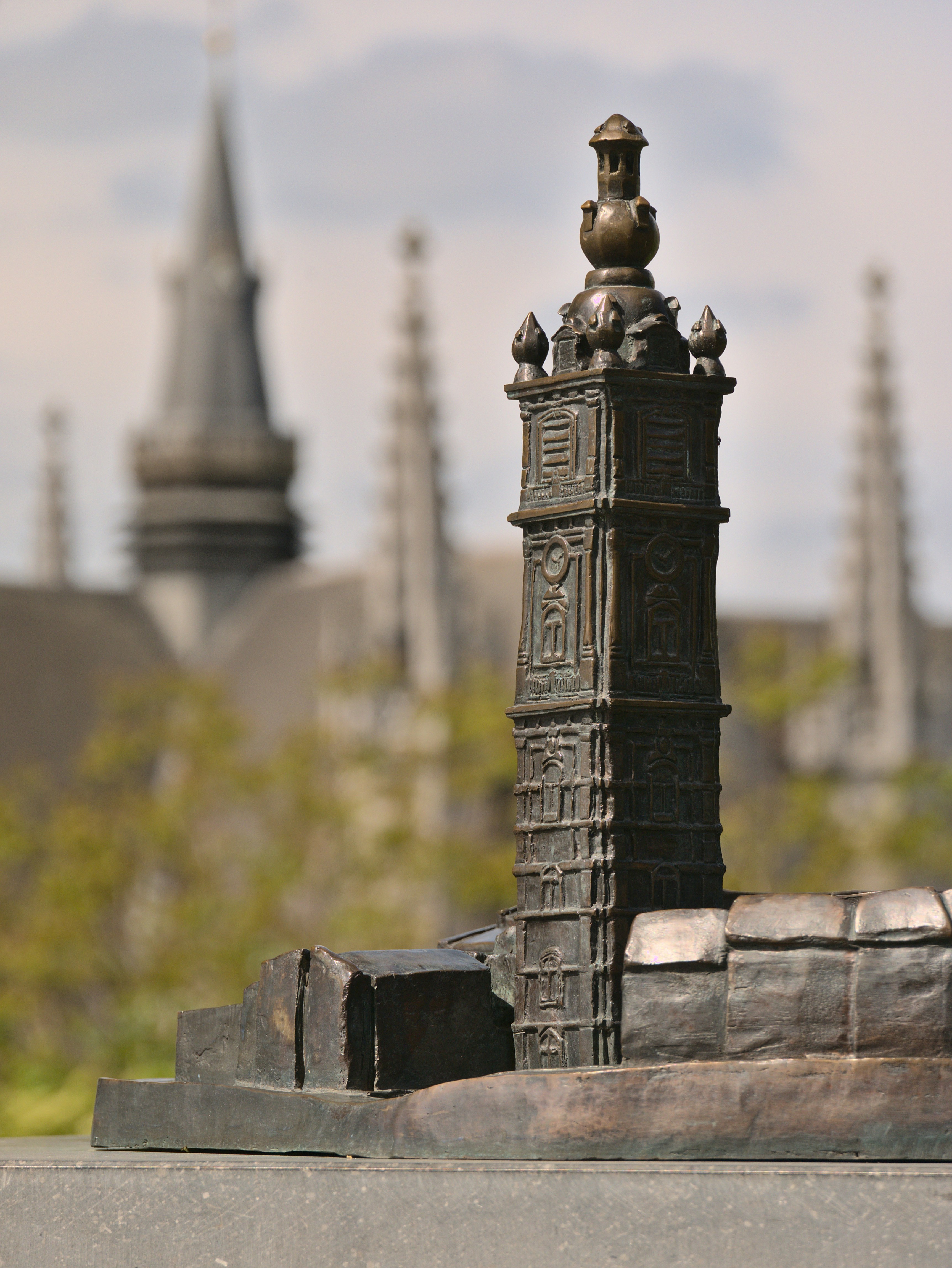 a statue of a tower with a clock on top of it