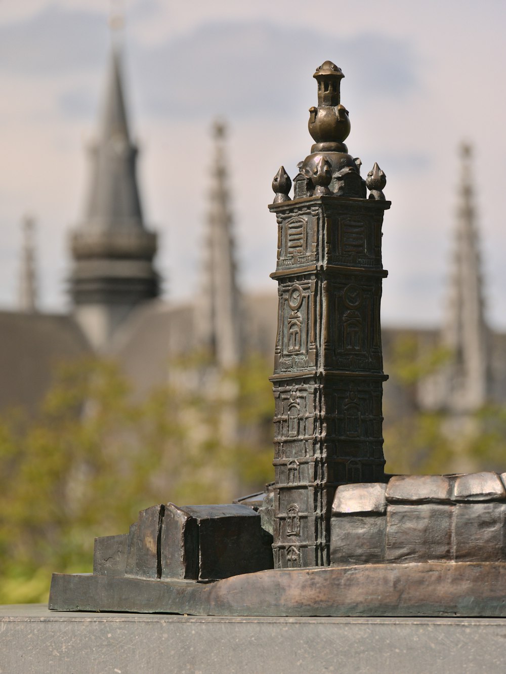 a statue of a tower with a clock on top of it