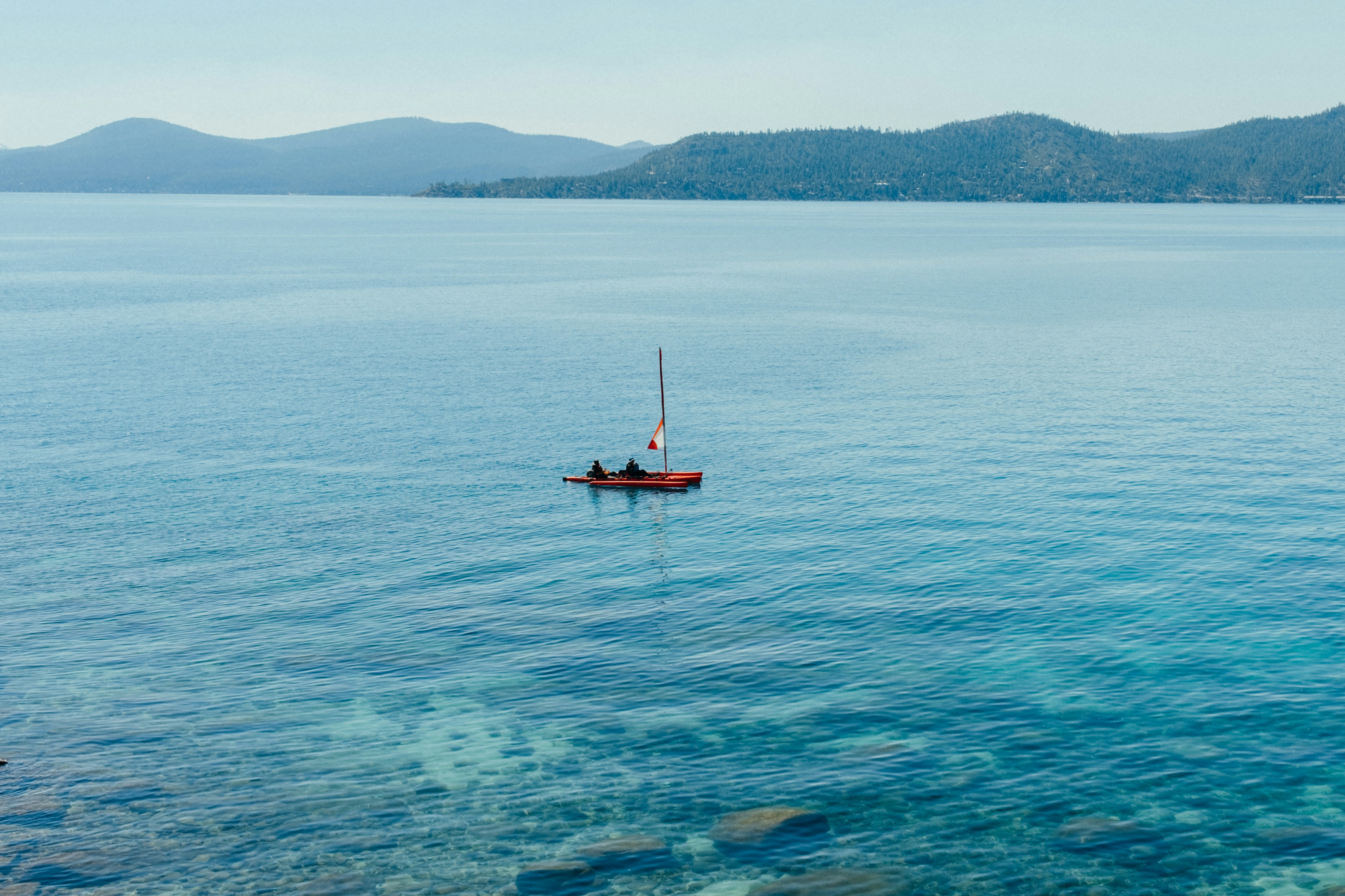 a small boat floating on top of a large body of water