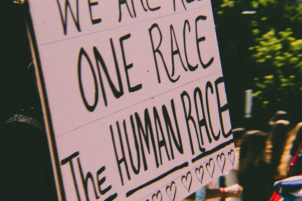 a sign that says we are all one race the human race