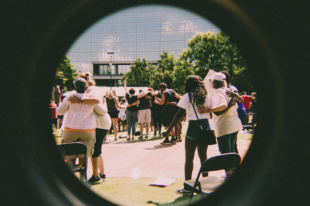 a group of people standing around each other