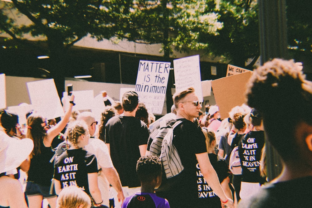 a group of people holding signs and protesting