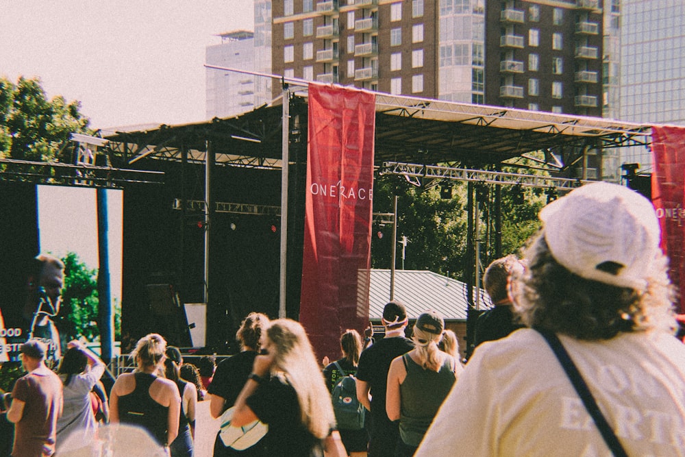 a crowd of people walking around a stage