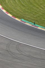 Close-up of a technical corner at Laguna Seca with tire marks visible.