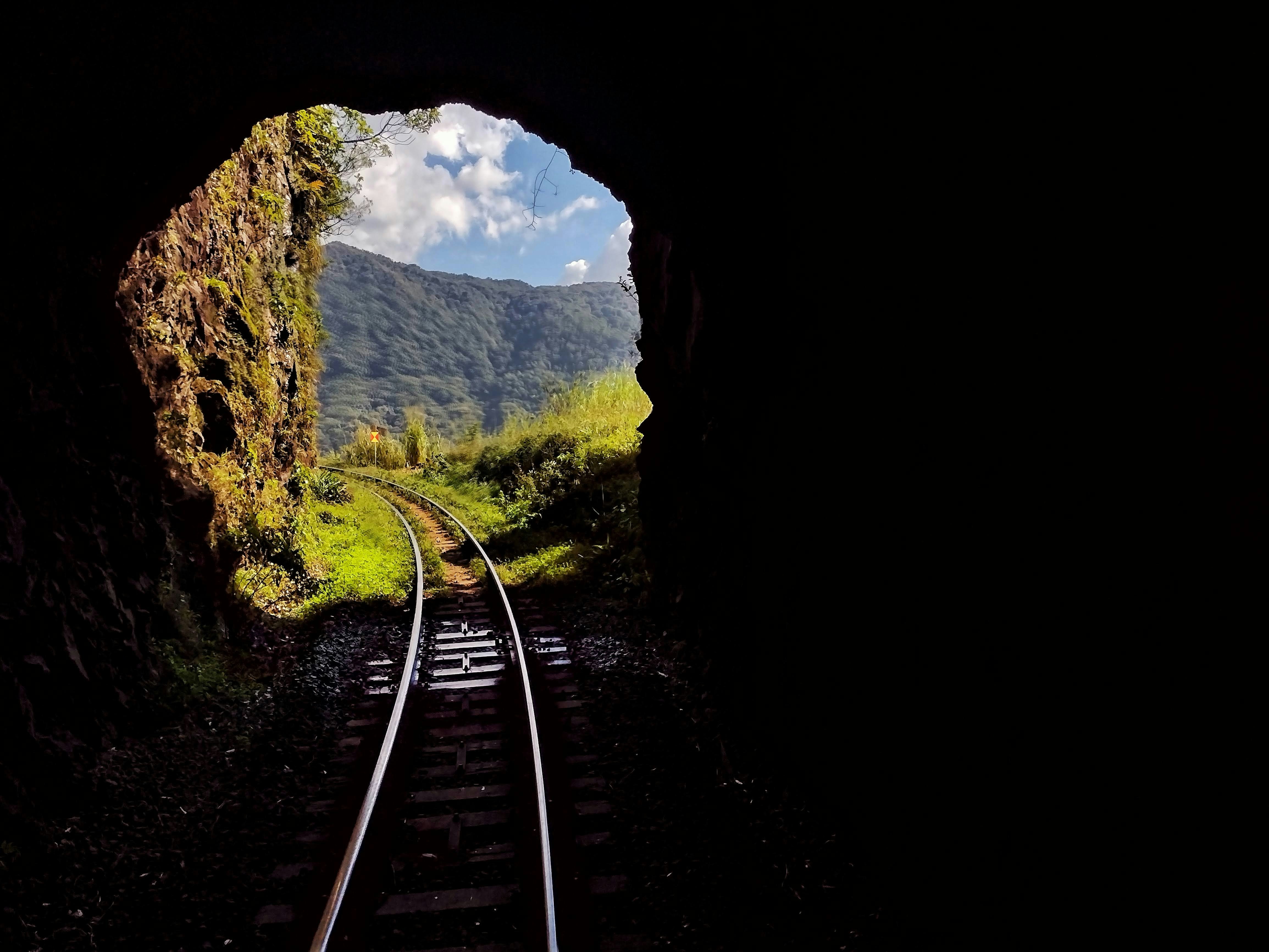 a view of a train track through a tunnel, Train ride between Curitiba and Morretes, Paraná, Brazil.