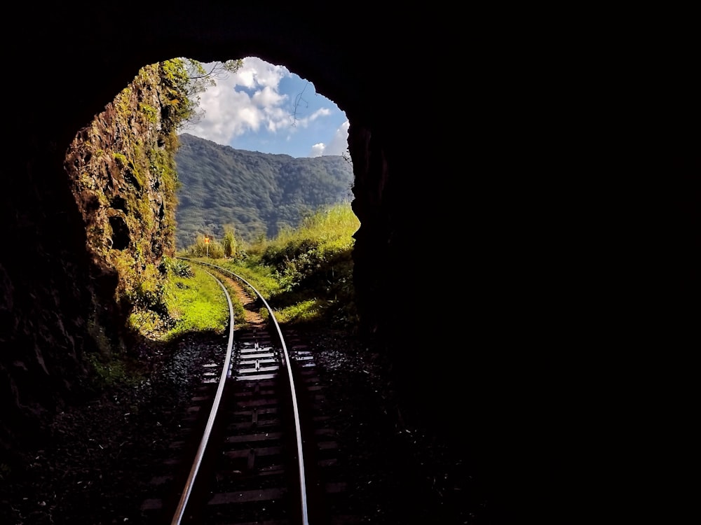 a view of a train track through a tunnel