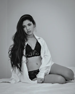 a woman sitting on a bed