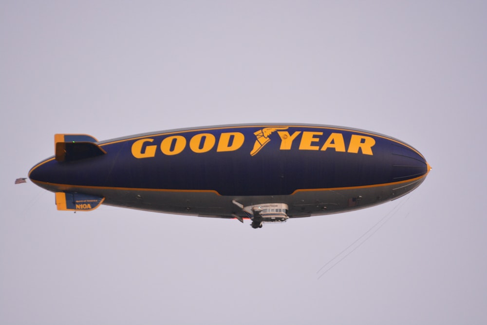 a large blue and yellow balloon flying in the sky