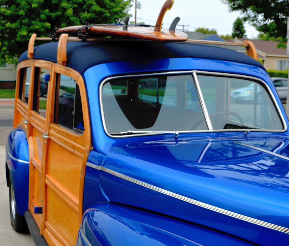 a blue car with a surfboard on top of it