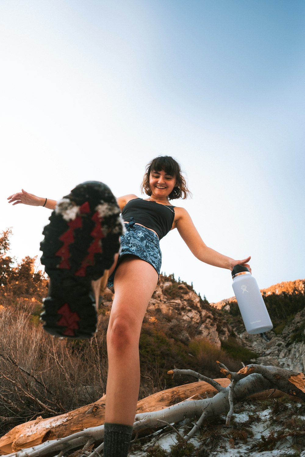 a woman in a short skirt holding a water bottle