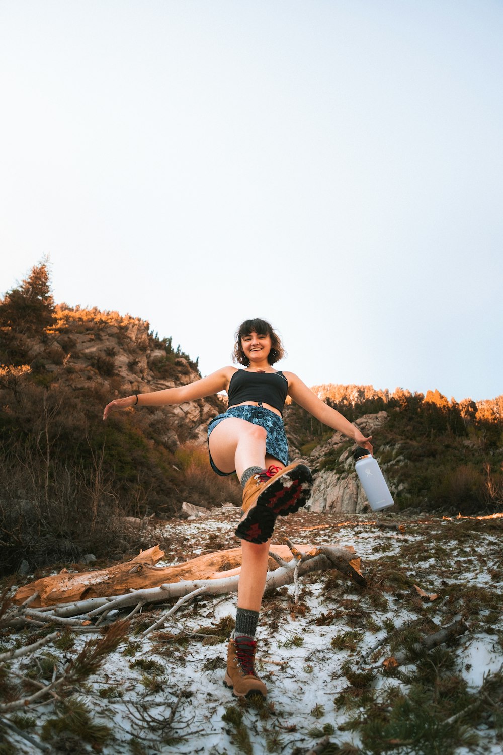 a woman is doing a trick on a snowboard