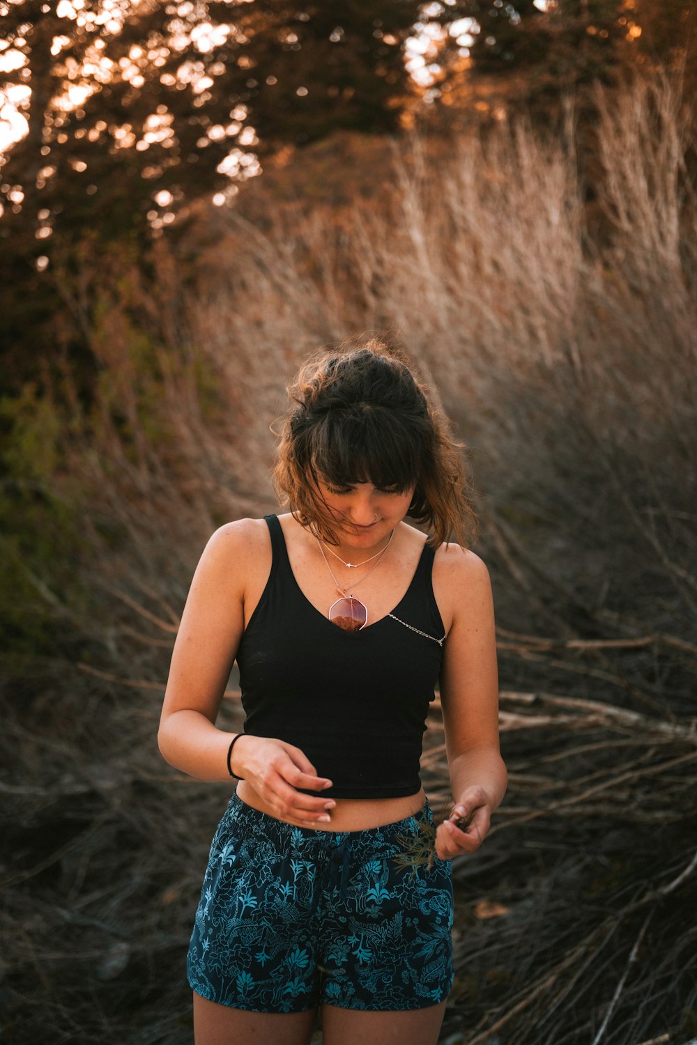 a woman in a black top and blue shorts