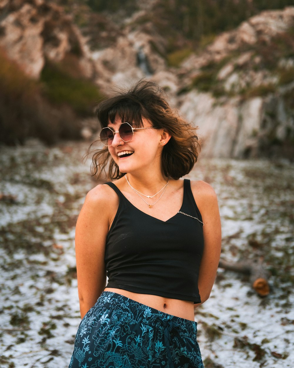 a woman in a black top and a blue skirt