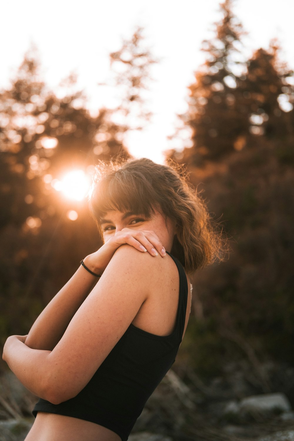 a woman in a black top is posing for a picture