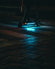 Sleek electric scooter glowing with electric blue accents in an urban night setting