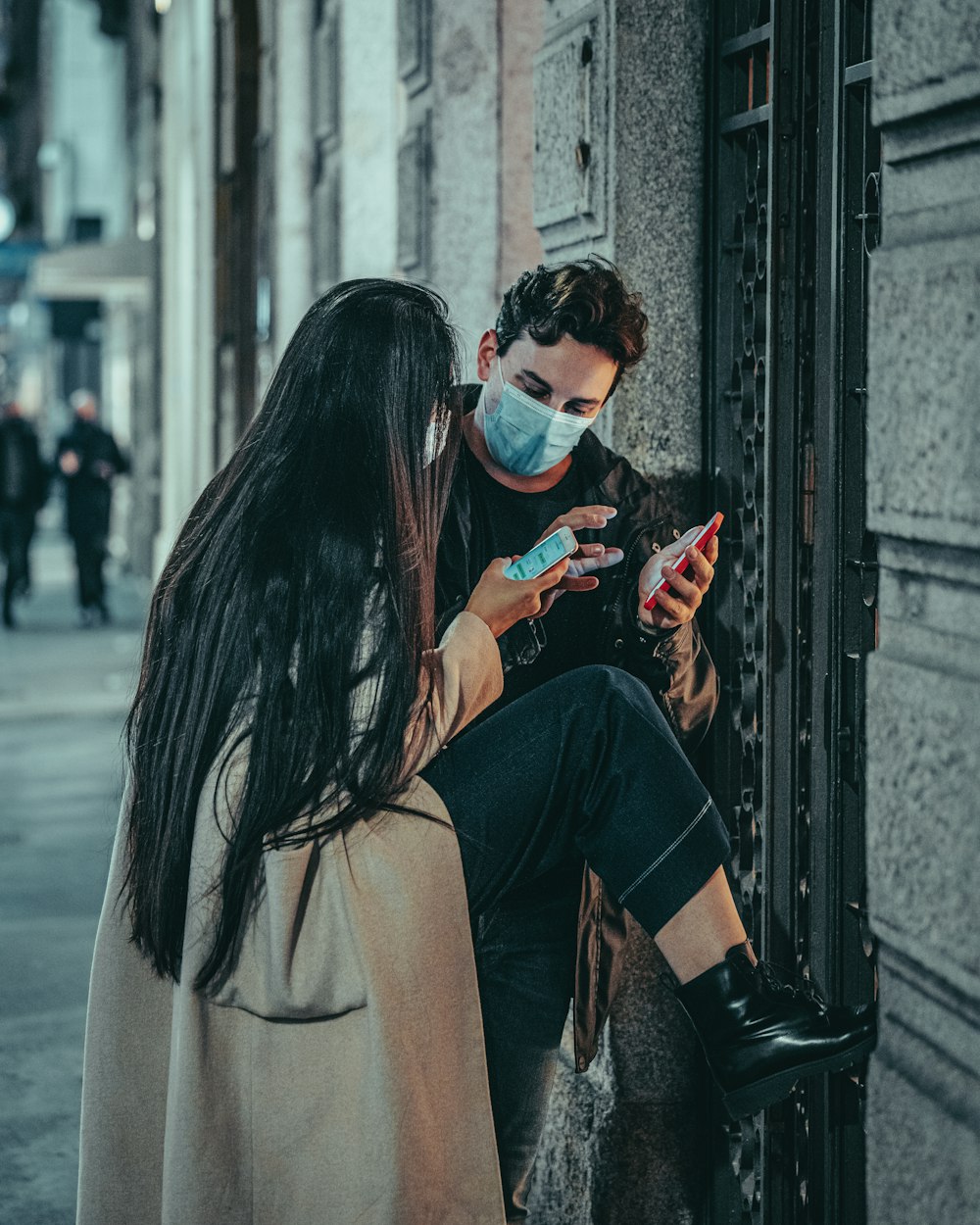 a woman in a face mask is looking at her phone