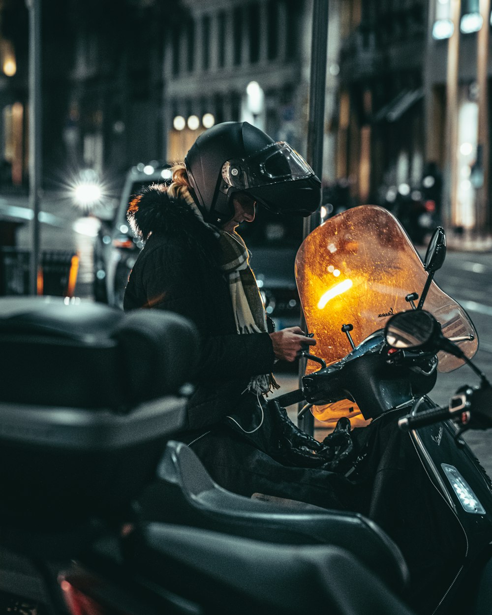 a person on a motor bike on a city street