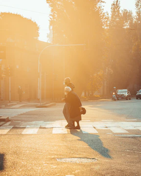 a person crossing a street at a crosswalk