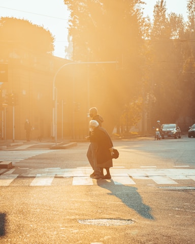a person crossing a street at a crosswalk
