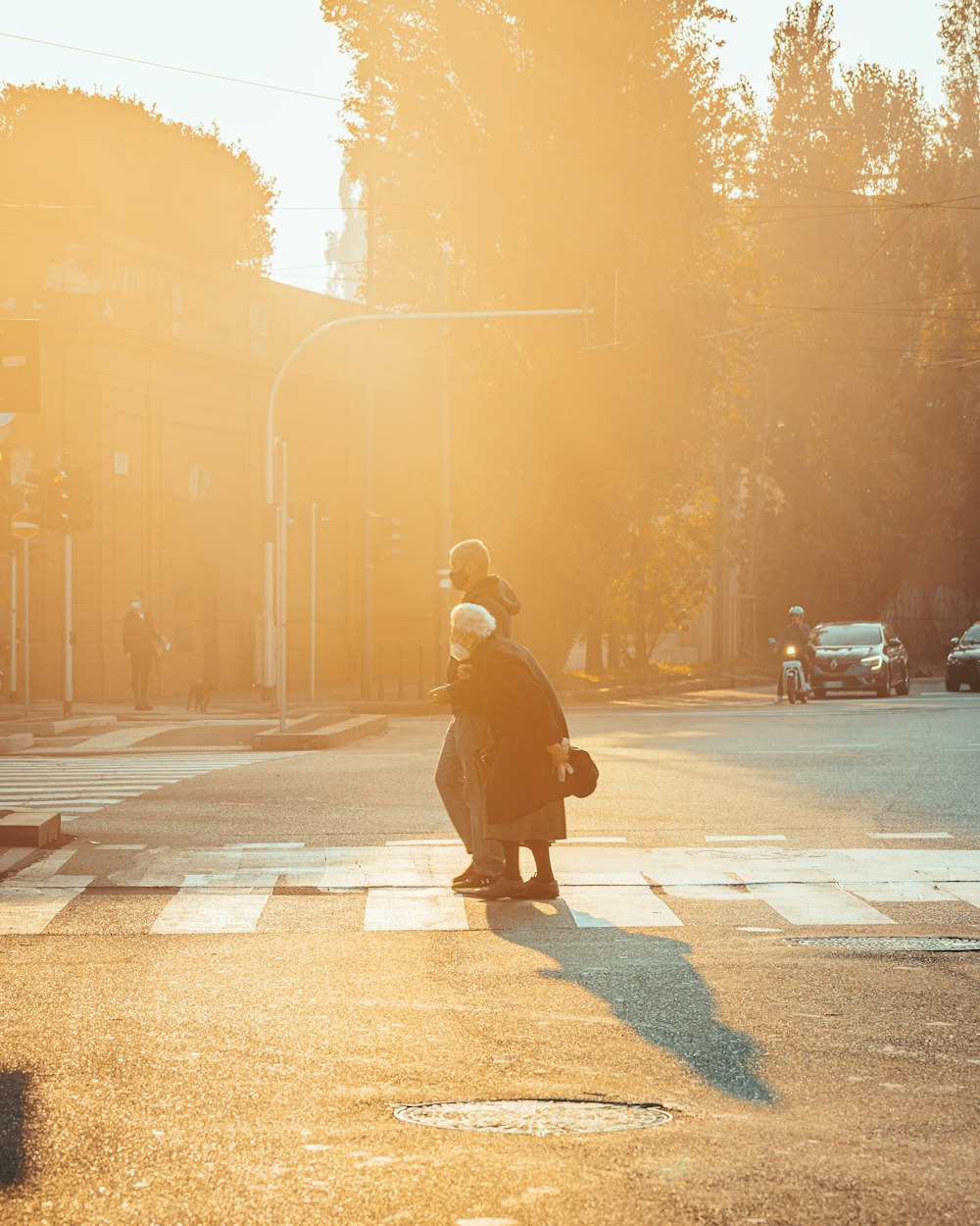 a person crossing a street at a crosswalk