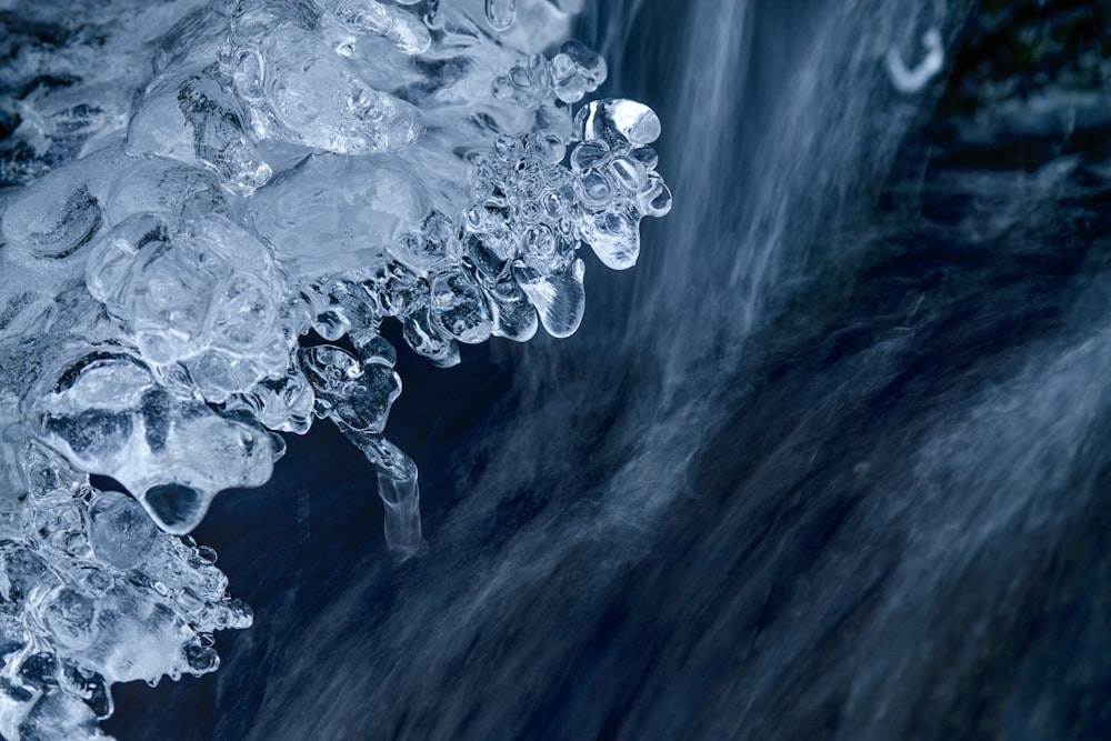 a close up of a waterfall with ice on it