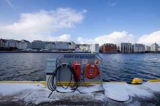 a gas pump on the side of a boat on a body of water