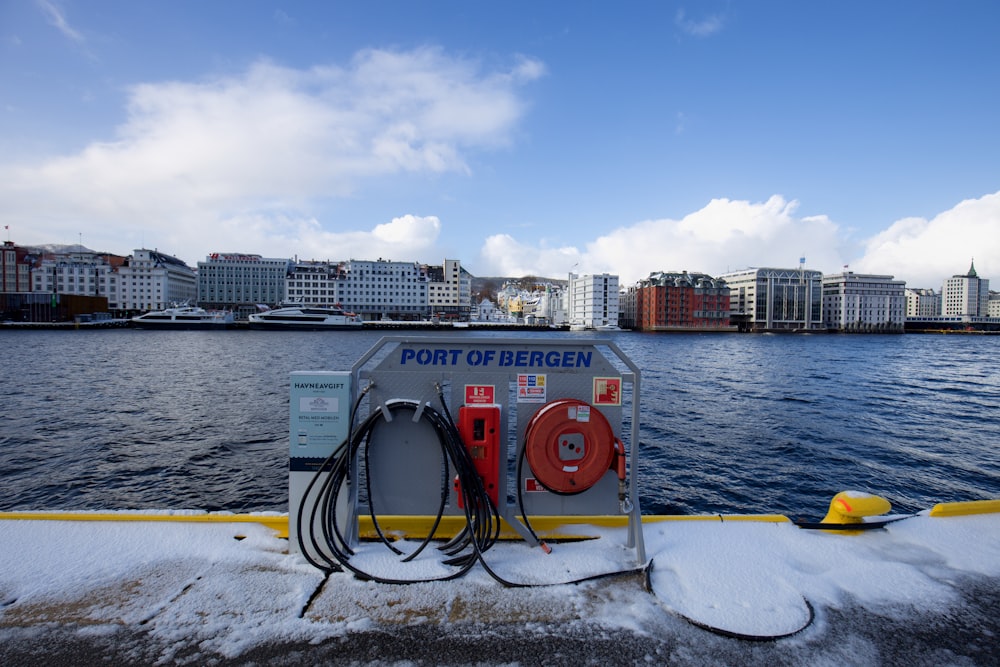 a gas pump on the side of a boat on a body of water