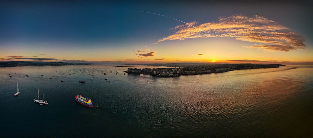 a group of boats floating on top of a large body of water