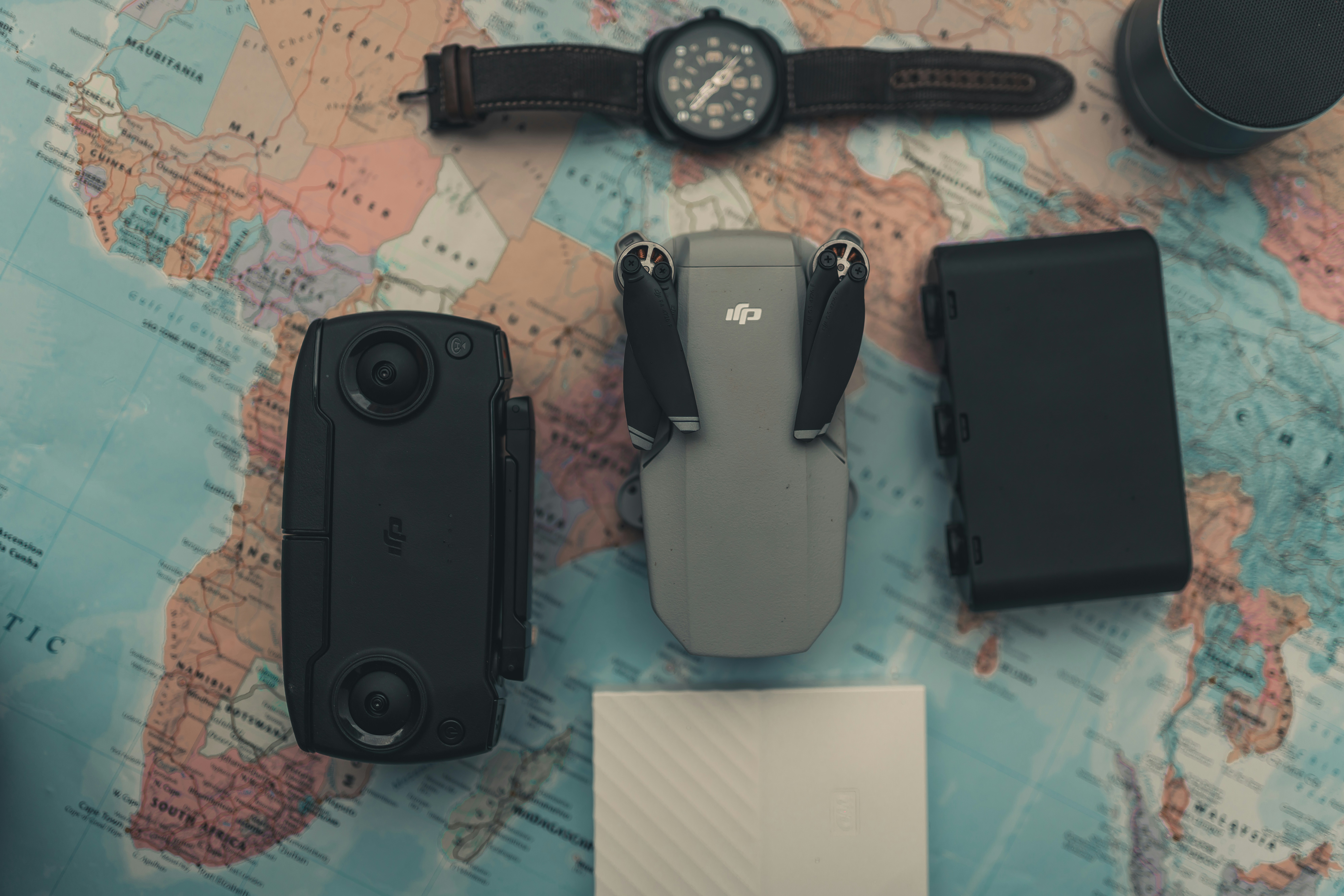 a map with a watch, camera, and other items on it, DJI Mavic Mini