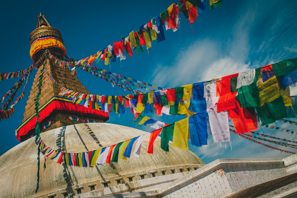 a large building with many colorful flags hanging from it's sides