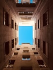 an empty room with a blue sky in the background