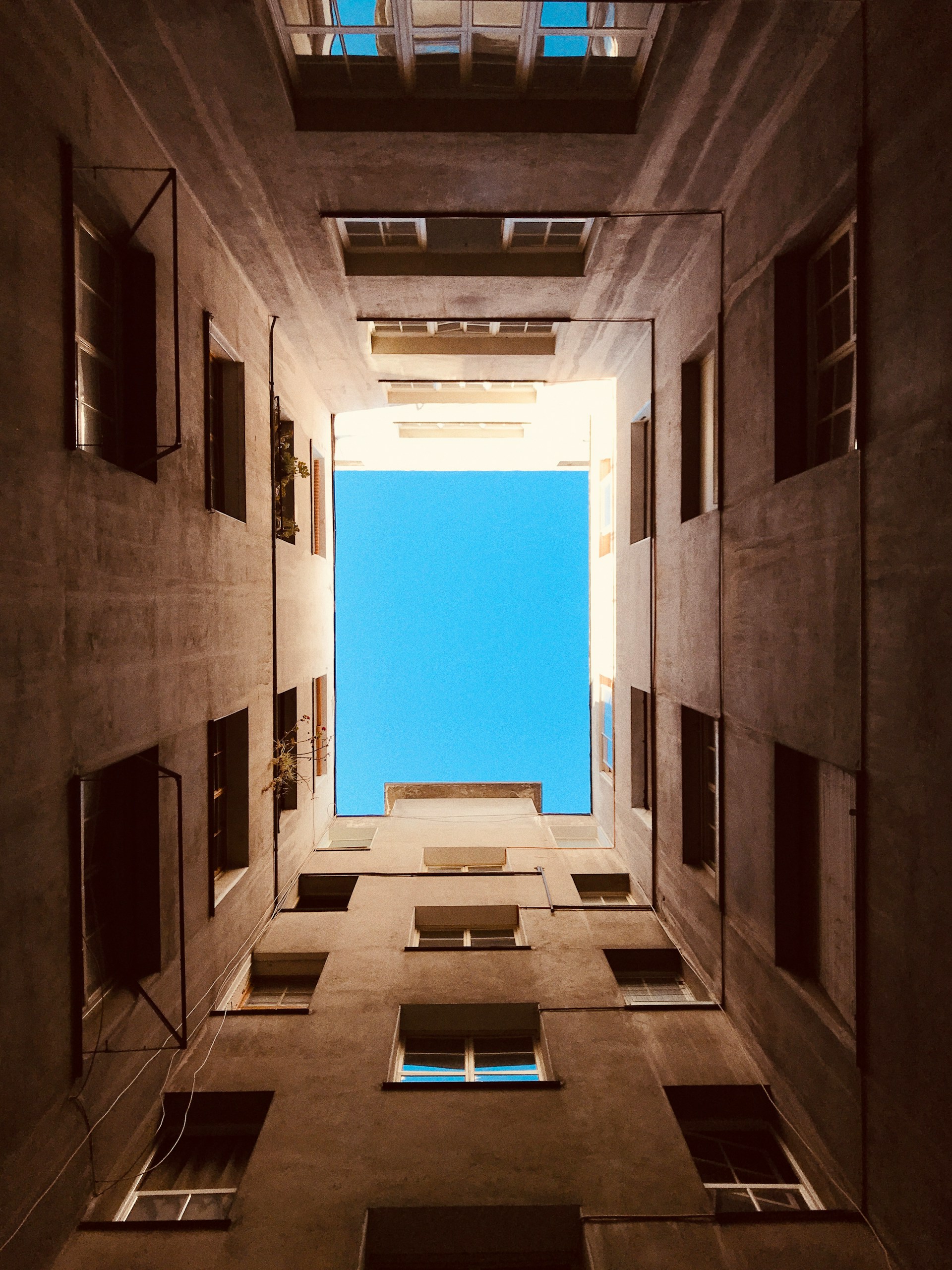 an empty room with a blue sky in the background