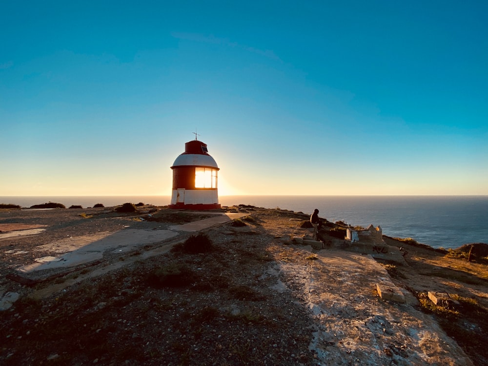 a light house on a rocky outcropping overlooking the ocean