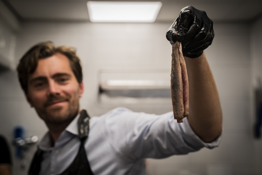a man holding a piece of meat in his hand