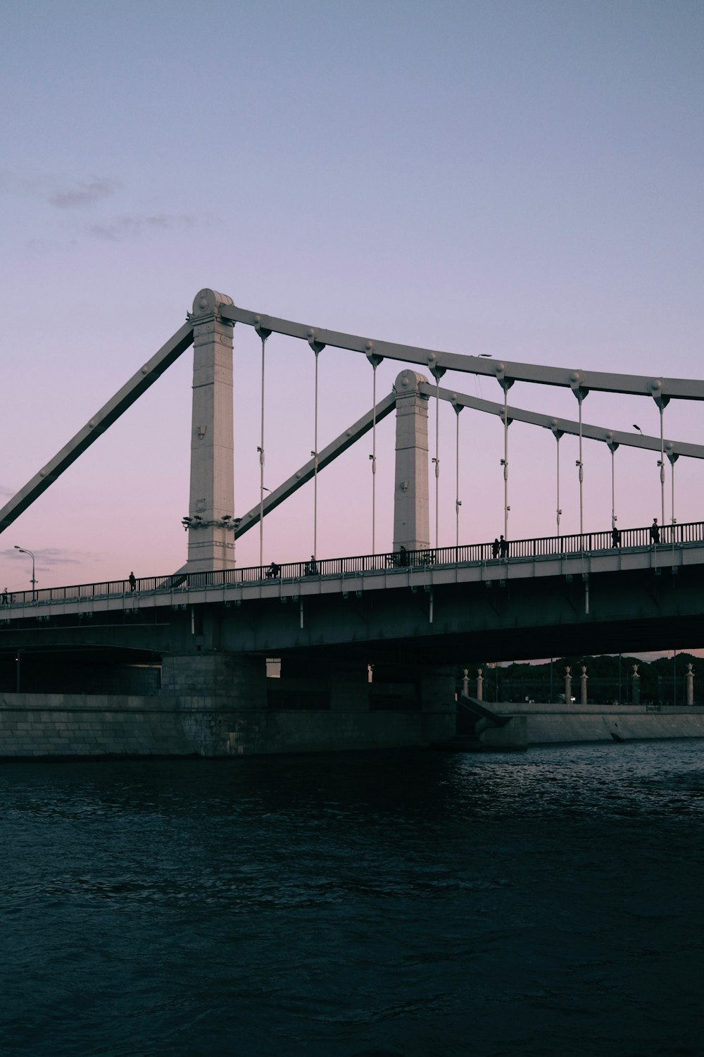 a bridge over a body of water at dusk