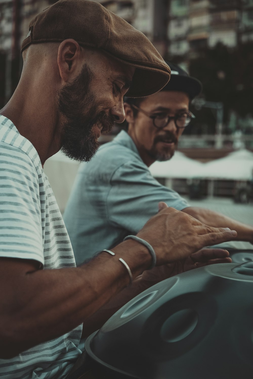 a couple of men sitting next to each other