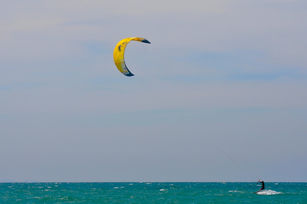 a person para sailing in the ocean on a sunny day