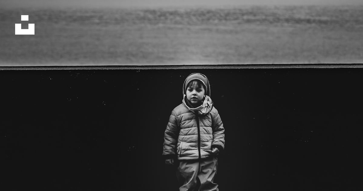 A Black And White Photo Of A Person Standing In Front Of A Body Of a-black-and-white-photo-of-a-person-standing-in-front-of-a-body-of
