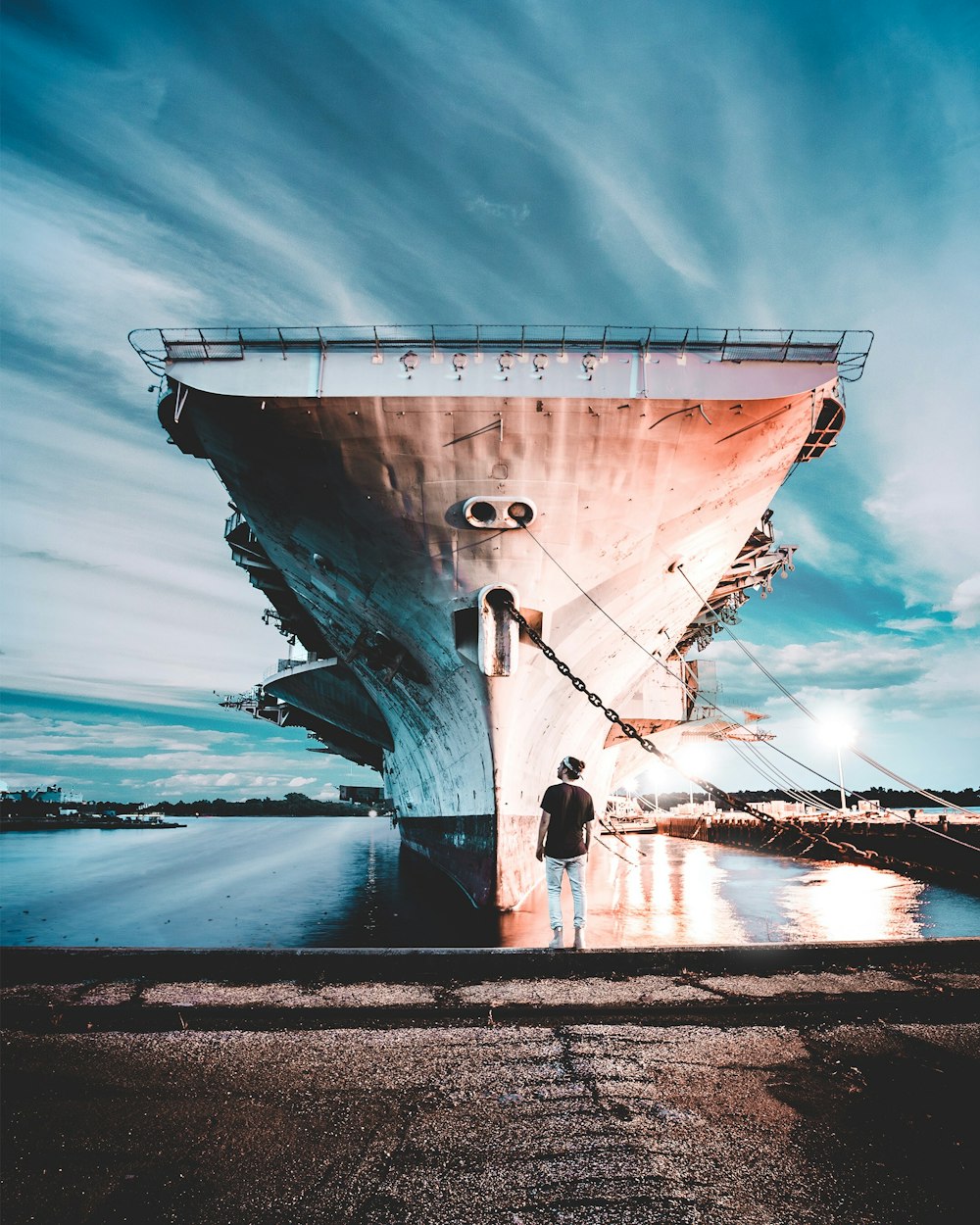 a man standing in front of a large ship