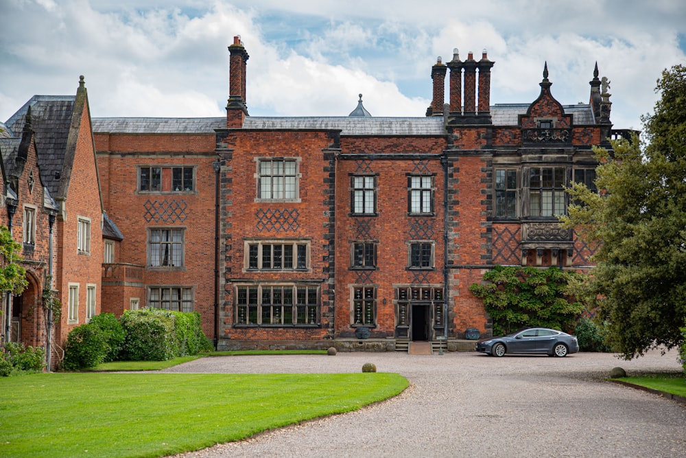 a car parked in front of a large brick building