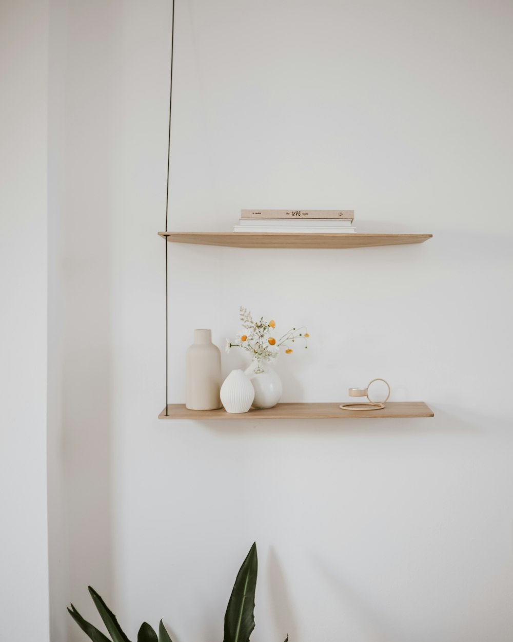 a couple of shelves that have vases on them