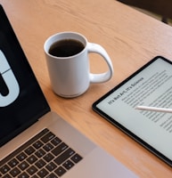 a tablet and a cup of coffee on a table